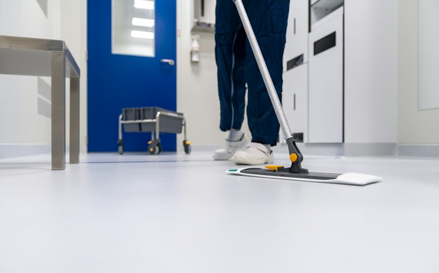 Operative mopping a bright corridor floor